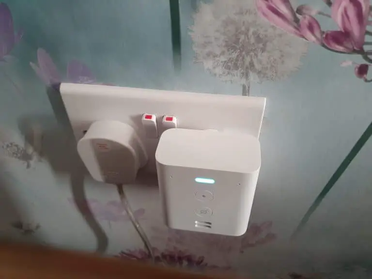 An Echo Flex smart speaker plugged into a wall socket