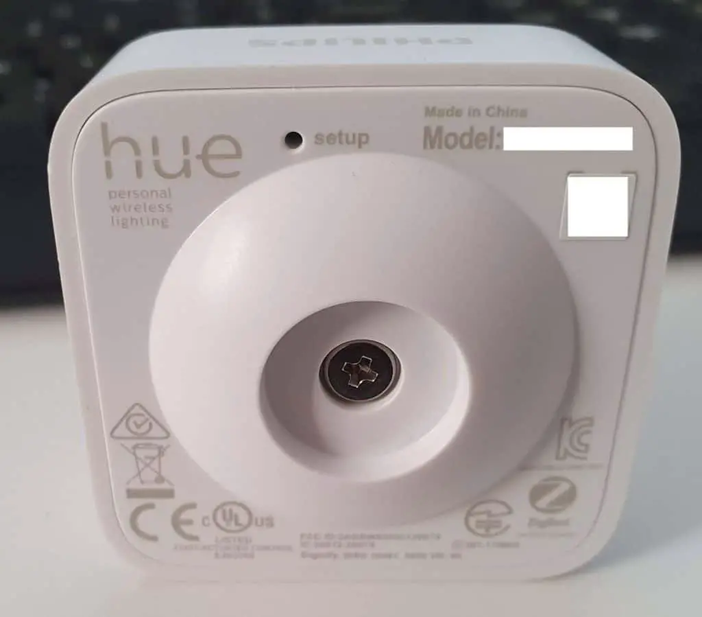 The back of a Hue Motion Sensor showing the reset button and battery compartment