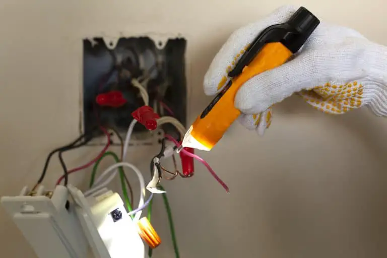An electrician is replacing a wall switch which includes a white neutral wire